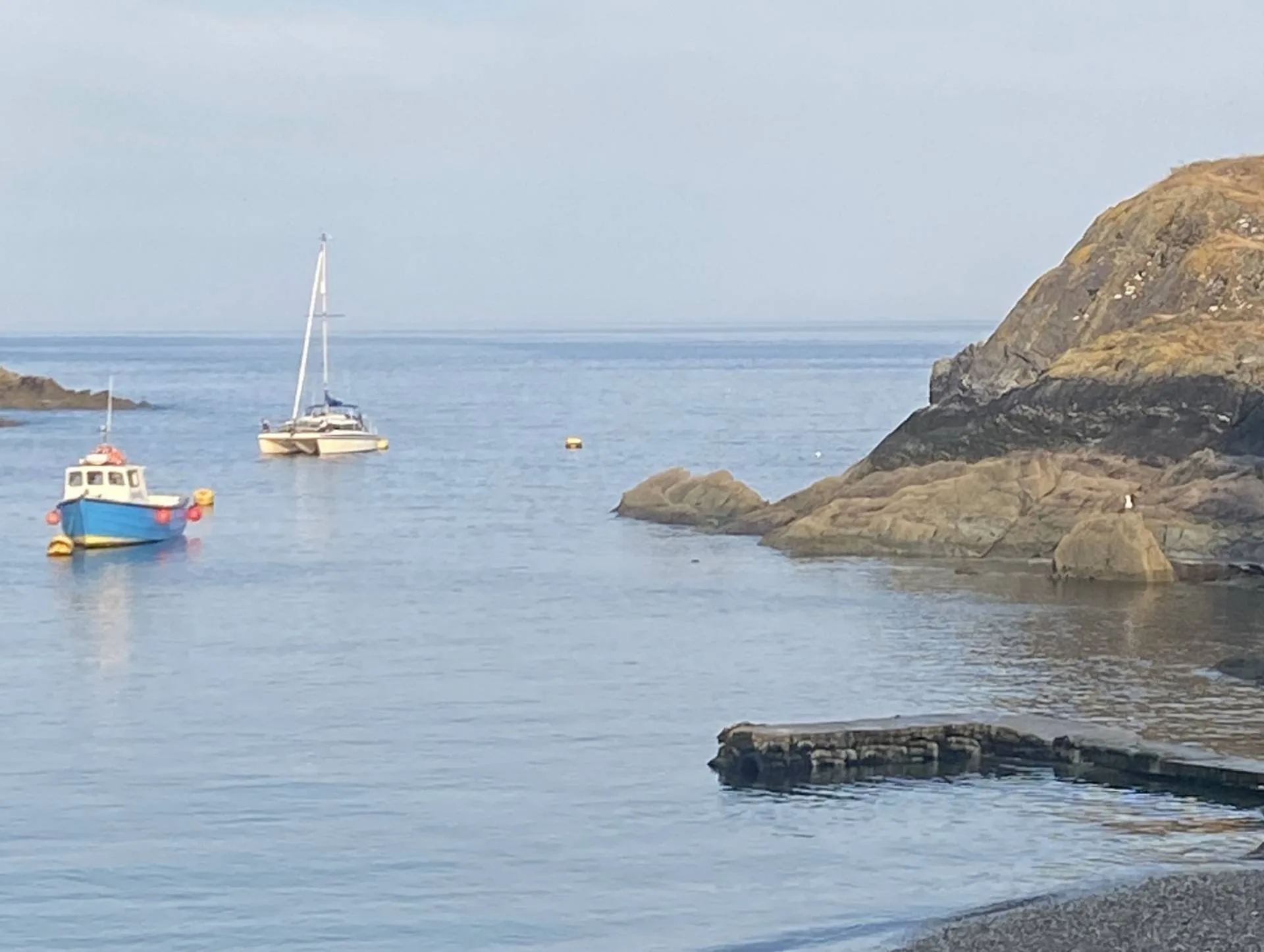 Boats and rocky coastline at Polperro